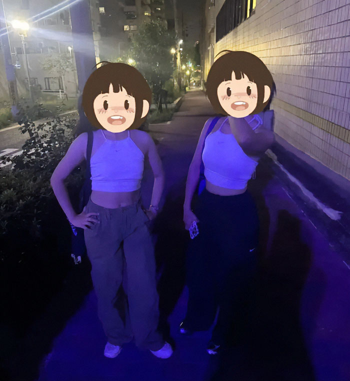 Two tourists in revealing sports attire posing outside a Japanese restaurant at night, sparking heated debate. Two tourists in revealing sports attire posing outside a Japanese restaurant at night, sparking heated debate.