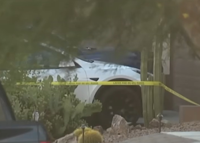 White car behind yellow police tape near desert plants at a crime scene linked to dad watched adult videos hot car case