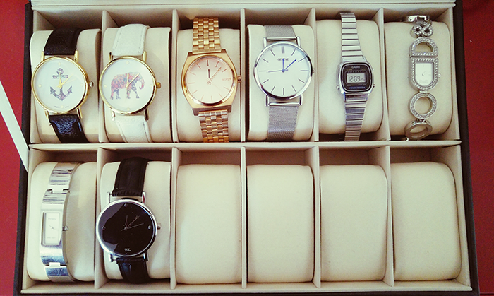 Collection of wristwatches and bracelets neatly arranged in a box, symbolizing time and a sister revealed dead brother lie.