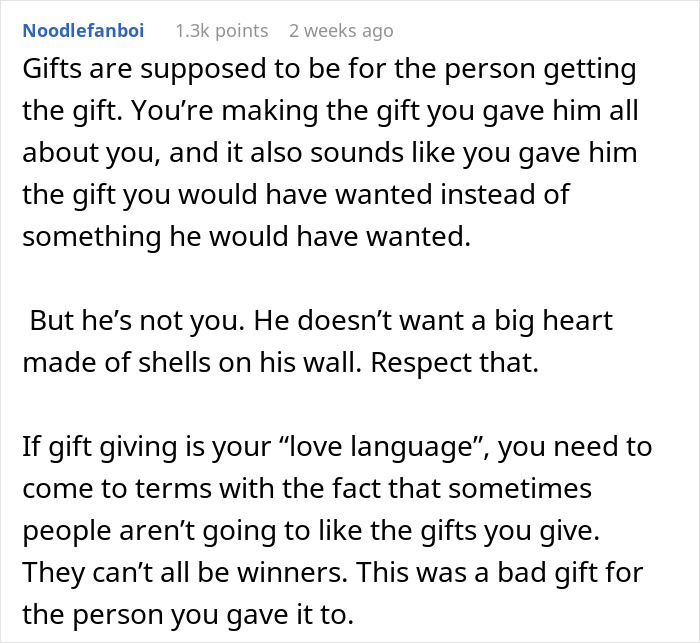 Comment explaining why boyfriend refuses to hang anniversary gift on wall, emphasizing respect for his preferences.