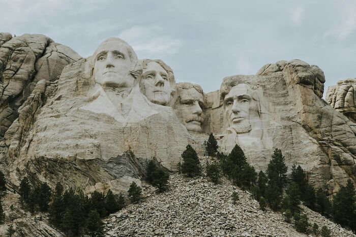 Mount Rushmore with carved faces of U.S. presidents symbolizing common truths later revealed as propaganda.