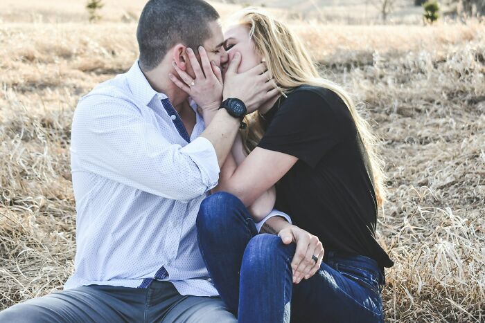 Couple sharing an intimate moment outdoors, illustrating emotions that wedding guests can unexpectedly evoke.