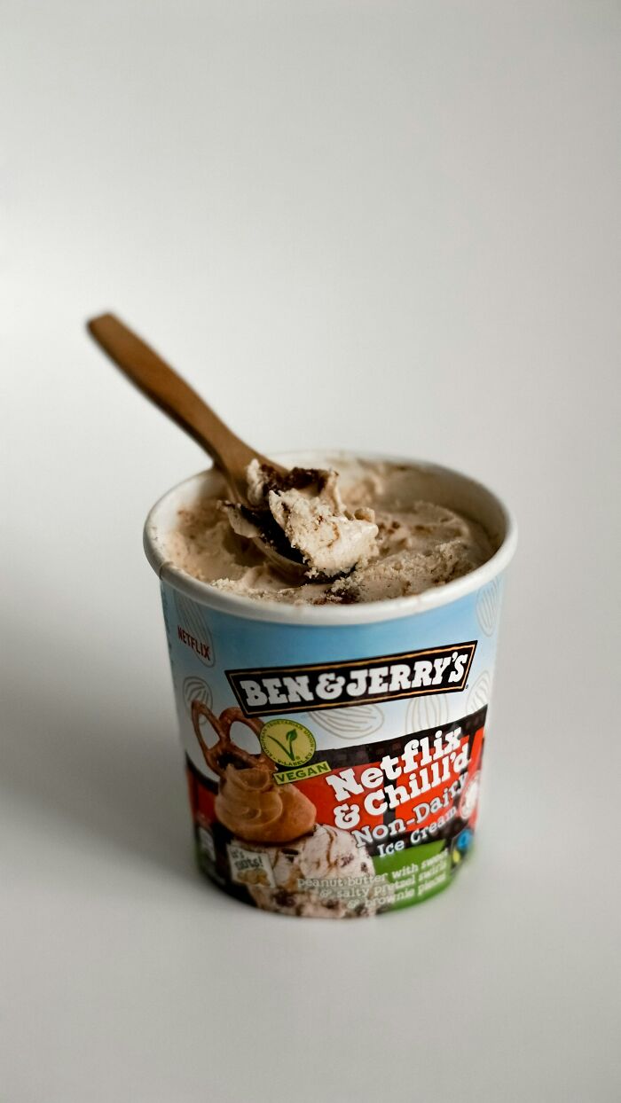 Ben & Jerry's ice cream tub with a wooden spoon, symbolizing secrets people are hiding from their partners.