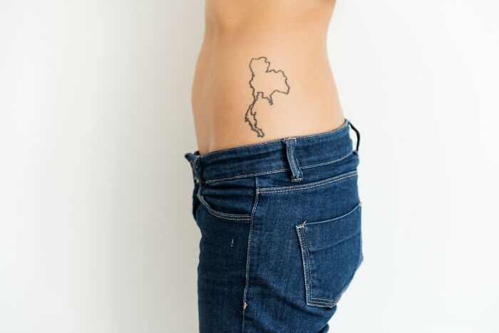 Close-up of a person’s side torso showing a small tattoo outline, illustrating tattoo artists messed up moments.