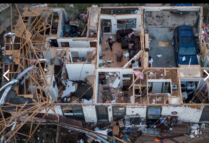 Aerial view of a destroyed house with exposed rooms showing nightmare situations surviving a severe storm.