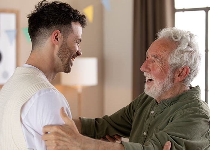 Older dad looking upset while talking to his adult son about daughter&rsquo;s home, expressing worry about it being too weird.