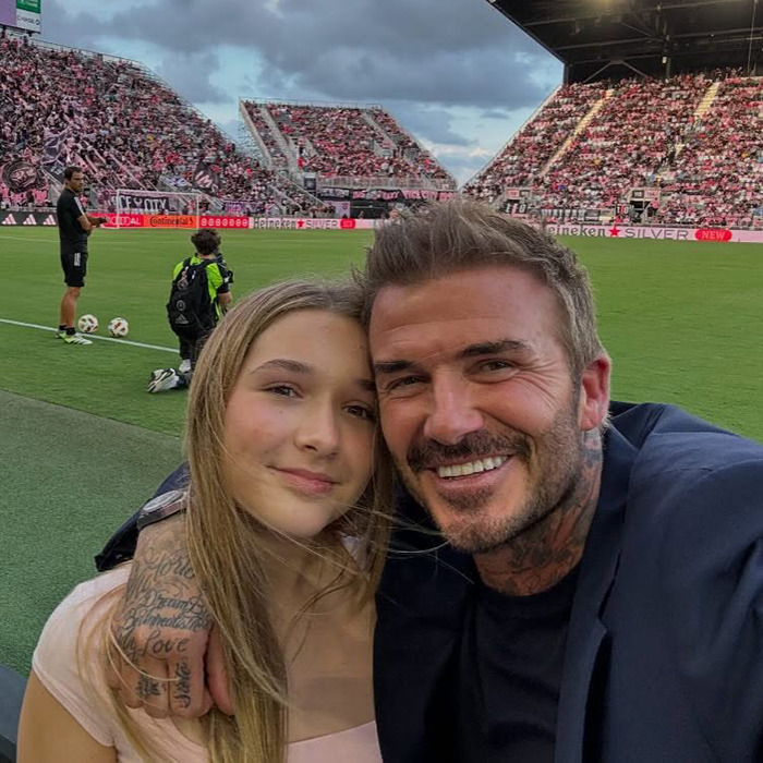 David Beckham with his daughter at a crowded soccer stadium, showing a very creepy relationship moment.