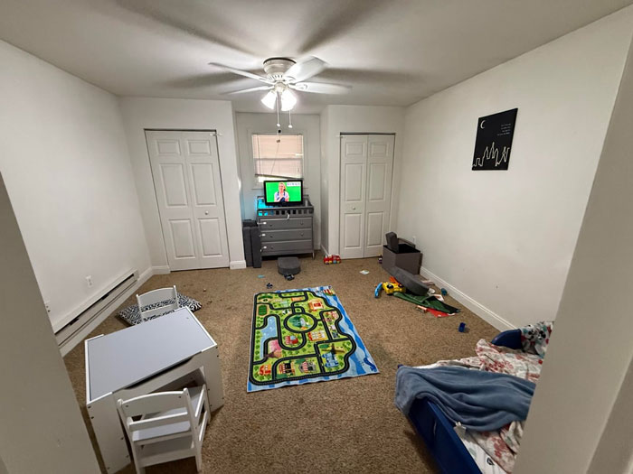 Playroom with scattered toys and kids' furniture, highlighting an exhausted mom's reality of a non-spotless house.