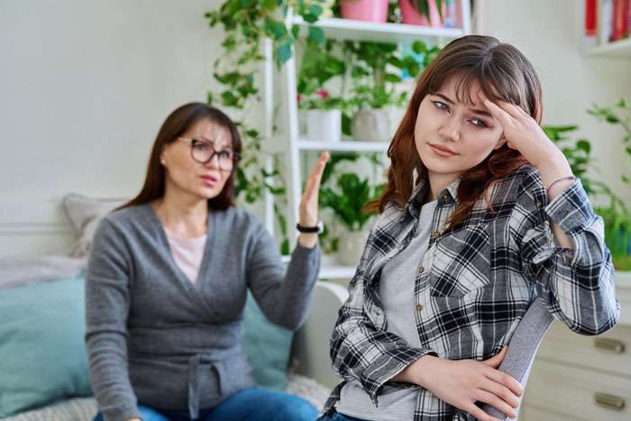 Woman obsessed with being bonus mom looks crushed as stepdaughter expresses frustration during a tense conversation at home.