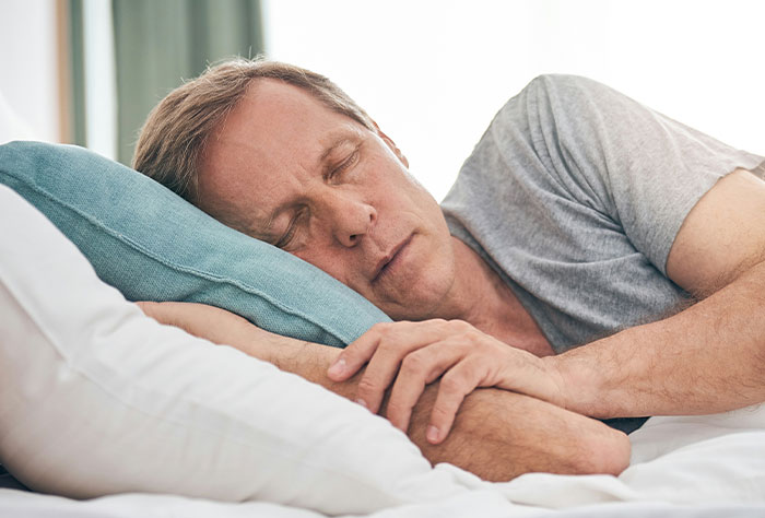 Middle-aged man sleeping peacefully in bed, illustrating cases where Google was accurate or wrong in diagnosing people.