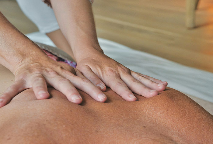 Hands performing a therapeutic massage on back, illustrating times Google was wrong or accurate in diagnosing people.