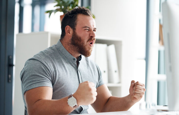 Man expressing excitement and surprise indoors, showing emotions related to craziest and funniest things during birth.