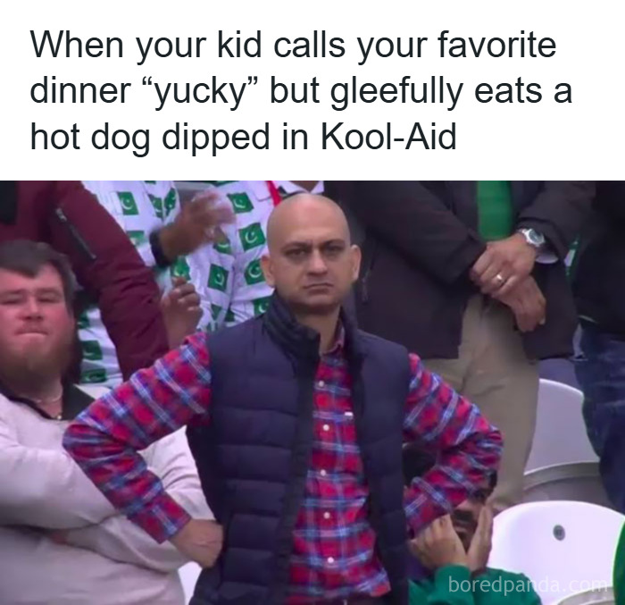Man with hands on hips looking unimpressed at a sports event, illustrating relatable parenting meme about kids and dinner.