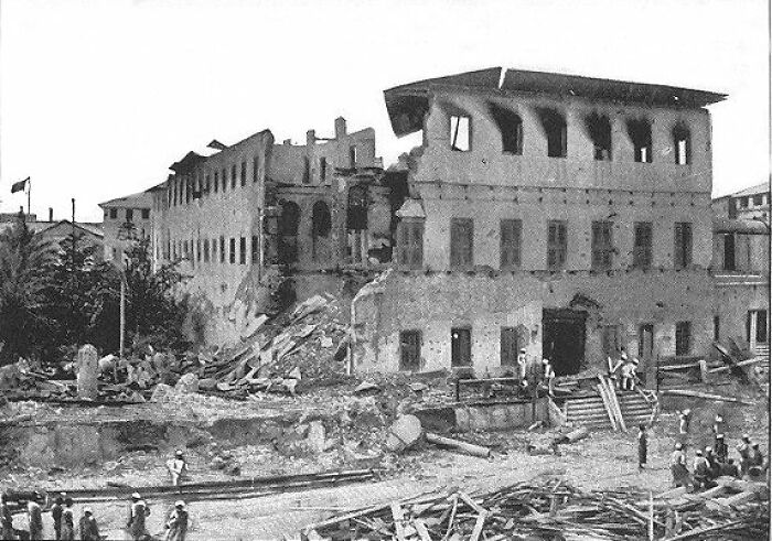 Black and white historical photo showing a damaged building with people nearby, illustrating rabbits once attacked Napoleon story.