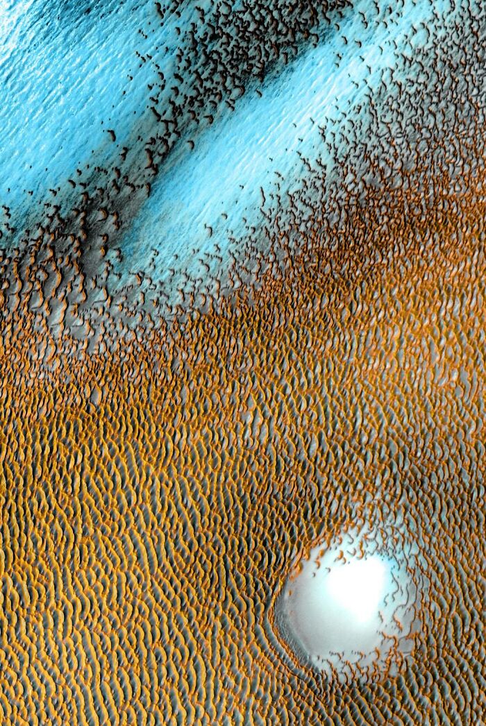 Aerial view of colorful sand dunes and frost patterns showcasing the beauty and mystery of space in astronomy photos.