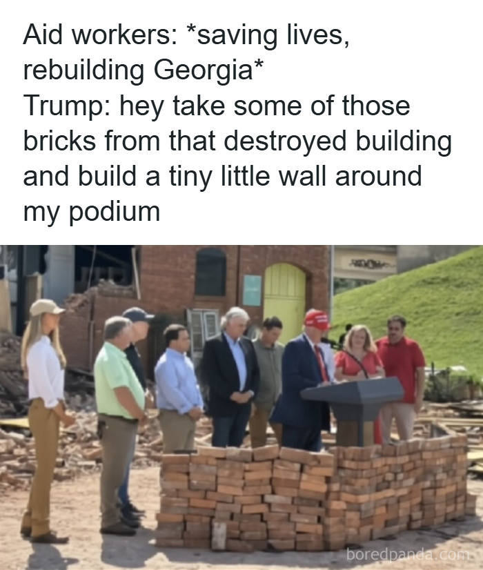 Group of people standing near a podium surrounded by a small brick wall showing a facepalm moment in logic and common sense.