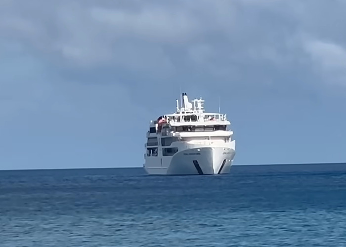 Cruise ship anchored near a remote island on Great Barrier Reef where elderly woman was found deceased.