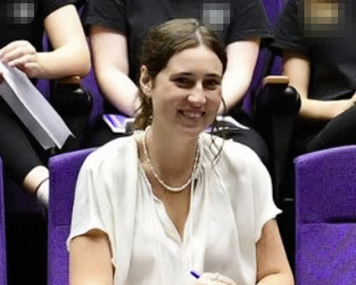 Woman smiling during family dinner scene, related to teen&rsquo;s shocking texts with teacher and subsequent arrest.