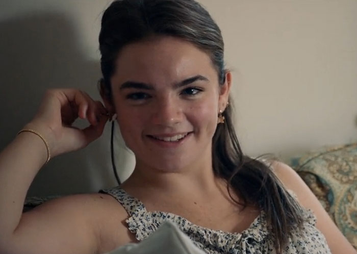 Young woman smiling casually indoors, illustrating Ben Stiller parenting mistakes after nepo baby kids criticism. Young woman smiling casually indoors, illustrating Ben Stiller parenting mistakes after nepo baby kids criticism.