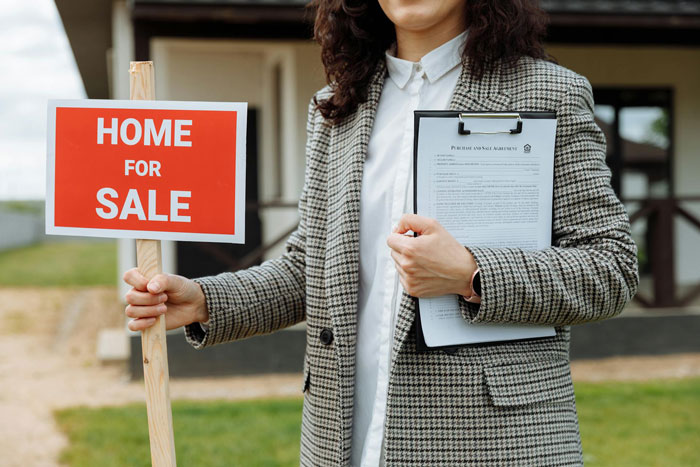 Woman holding home for sale sign and real estate documents, symbolizing wife starting a new life with lover after cheating. Woman holding home for sale sign and real estate documents, symbolizing wife starting a new life with lover after cheating.