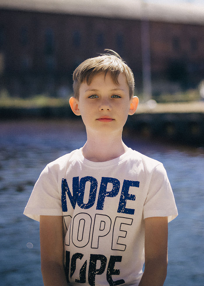 Young boy outdoors wearing a white shirt, representing the first grade teacher topic in a viral private parts song debate. Young boy outdoors wearing a white shirt, representing the first grade teacher topic in a viral private parts song debate.