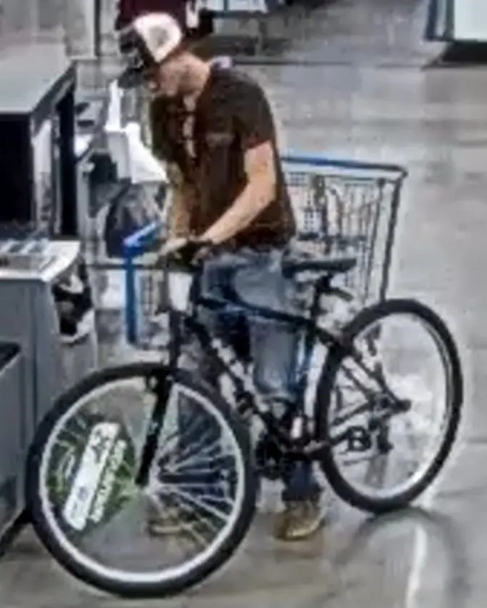 Teen with bicycle in a store, involved in faked kidnapping incident discovered by cops.