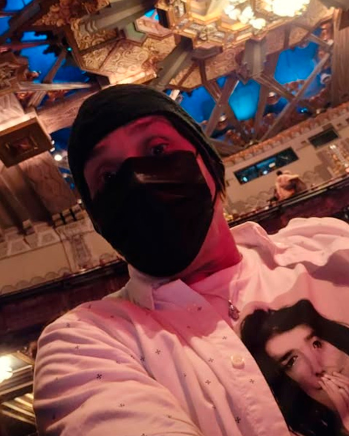 Man wearing a black mask and patterned shirt indoors with ornate ceiling, highlighting former Red Hot Chili Peppers star homelessness.