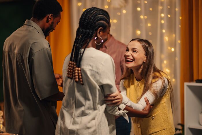 A group of friends laughing and sharing funny moments, illustrating drunk fumbles and hilarious fails at a party.