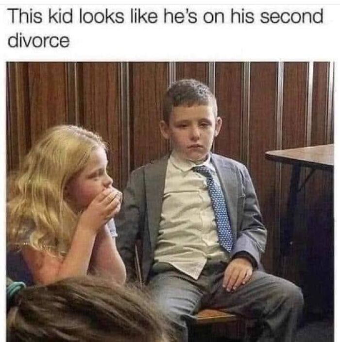 Two kids sitting indoors, one looking serious and dressed in a suit, a funny meme about memes to laugh at.