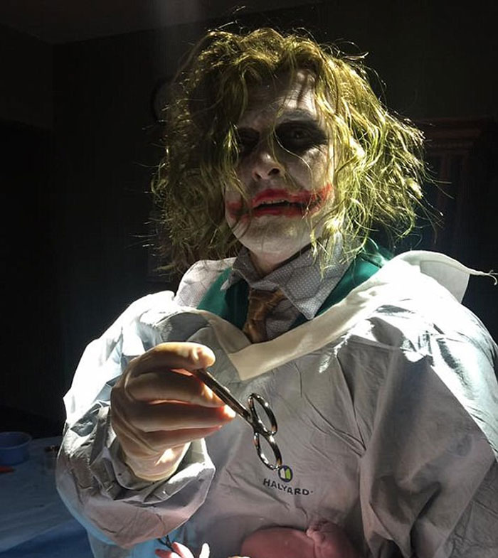 Doctor in costume with makeup holding surgical tools during a playful moment to put patients at ease.