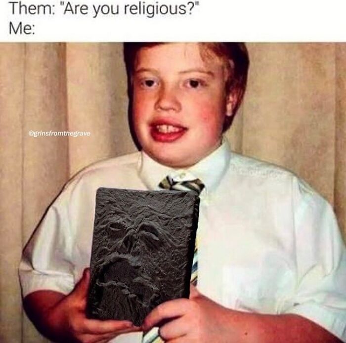 Young boy holding a horror book with a face design, a funny meme perfect for hilarious horror movie memes fans.