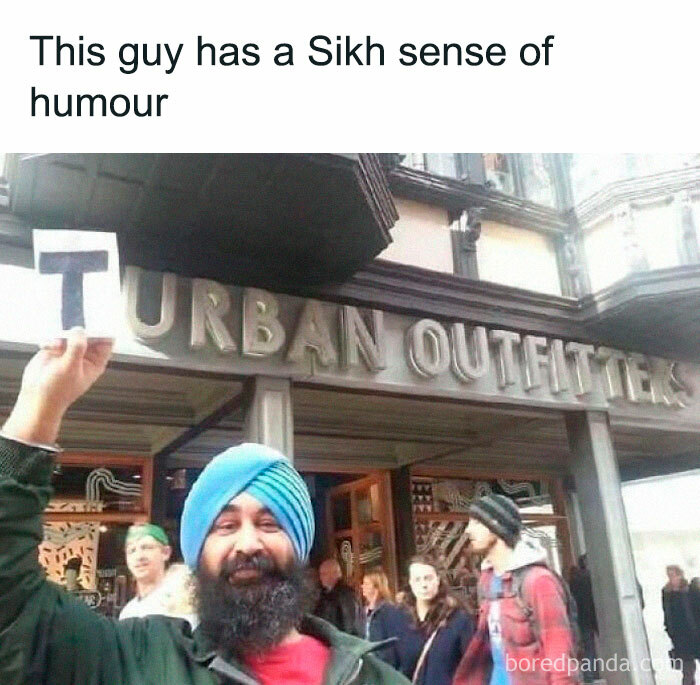 Man with blue turban holding letter T in front of Urban Outfitters store, illustrating cringy jokes and puns to send to your dad.