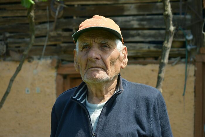 Elderly man wearing a cap and jacket, standing outdoors, representing terrifying medical conditions with no symptoms.
