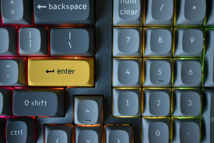 Close-up of a computer keyboard with a yellow enter key, highlighting simple car stuff skills for maximum results.