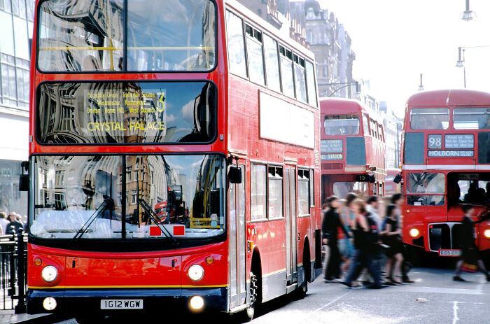 Red double-decker buses on a busy street with pedestrians, illustrating 72 times someone witnessed near-death experiences.