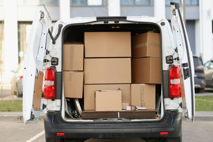 White van packed with cardboard boxes, illustrating the concept to zip-line your boxes out for easier moving tasks.
