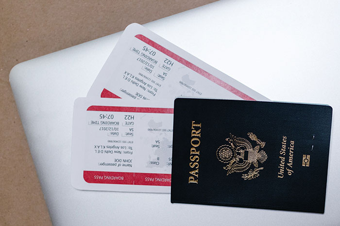 US passport and airline boarding passes on a white surface, representing travel plans and cruise vacation ideas. US passport and airline boarding passes on a white surface, representing travel plans and cruise vacation ideas.