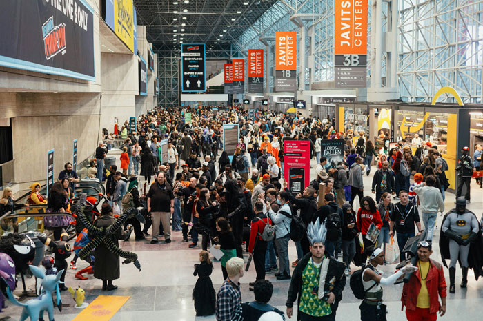 Crowded convention center with cosplayers and attendees, highlighting relationship tension and trip reconsideration themes.