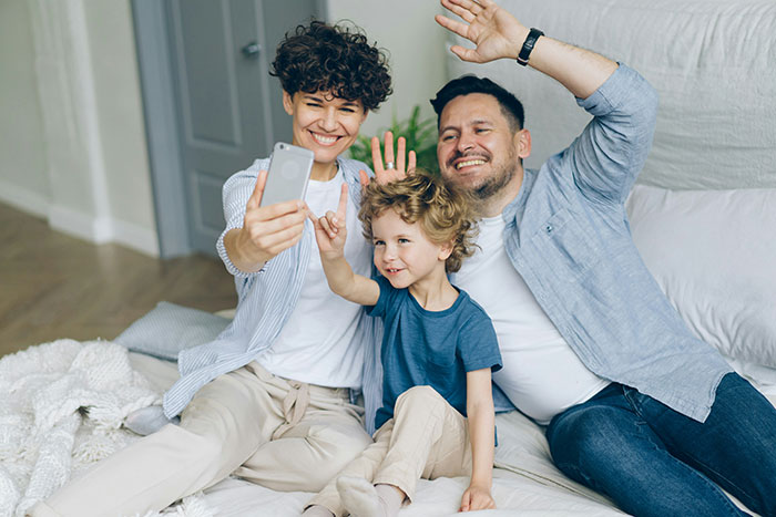 Family taking a selfie together, capturing joyful moments with famous family members in a cozy home setting.