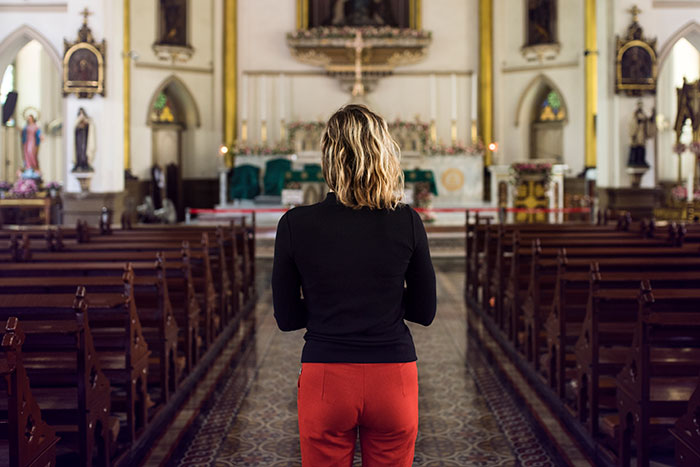 Person standing alone in a church aisle reflecting on moments with famous family members and what it's like to discover them.
