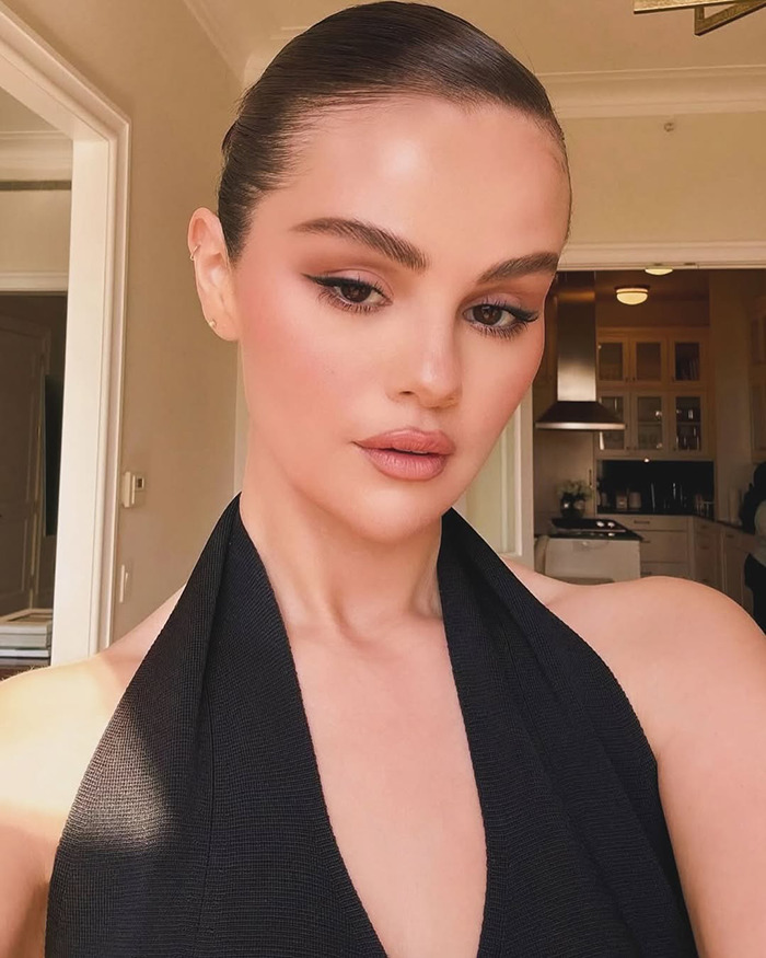 Hailey Bieber posing indoors with sleek hair and makeup, linked to reopened Selena Gomez feud and shady diss keywords.