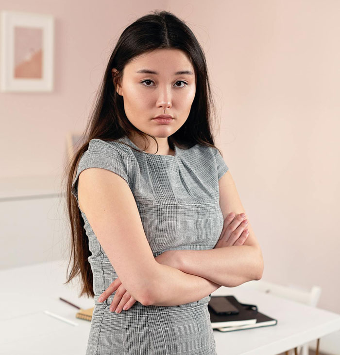 Young woman looking upset with arms crossed, illustrating conflict over friend offering favor instead of cash help.