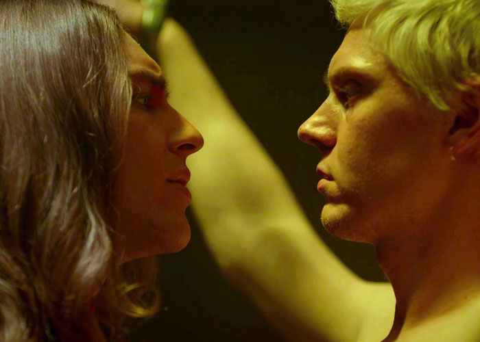 Two people facing each other closely, portraying tension linked to masculinity so fragile and relationship conflict.