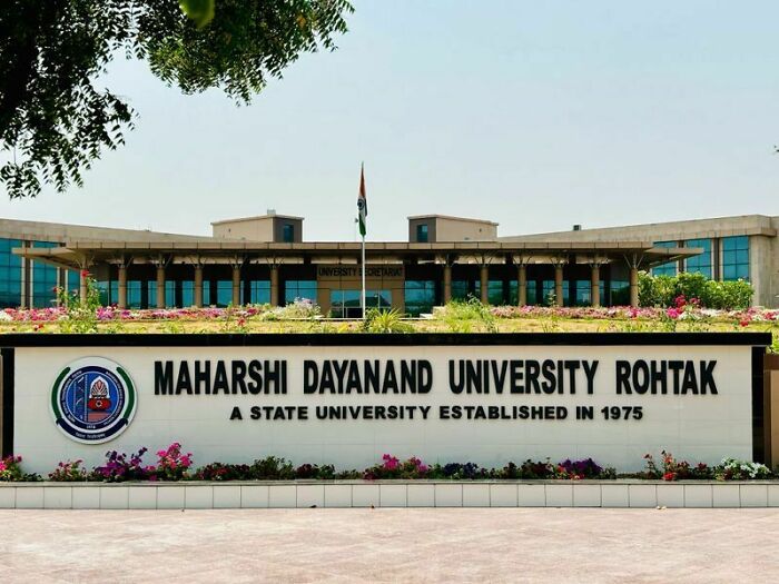 Maharshi Dayanand University campus with a sign, related to university requiring female staff to photograph sanitary pads.