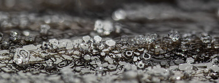 Close-up microscopic image showing detailed crystalline structures in the 2025 Nikon Small World photomicrography contest.