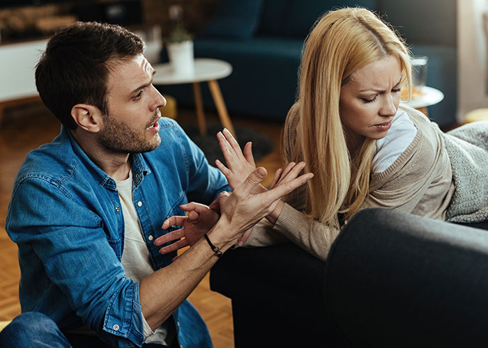 Man expressing frustration while woman looks away upset in a tense moment illustrating relationship icks men lose interest in.