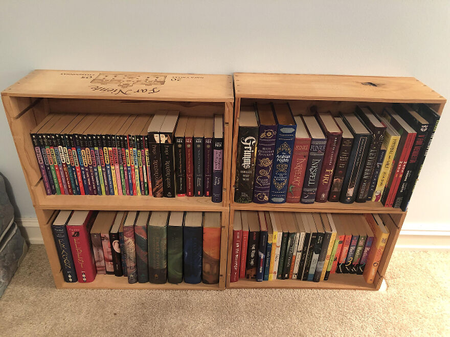 Wooden crates used as bookshelves showcasing organization hacks for home with neatly arranged books and compact storage.