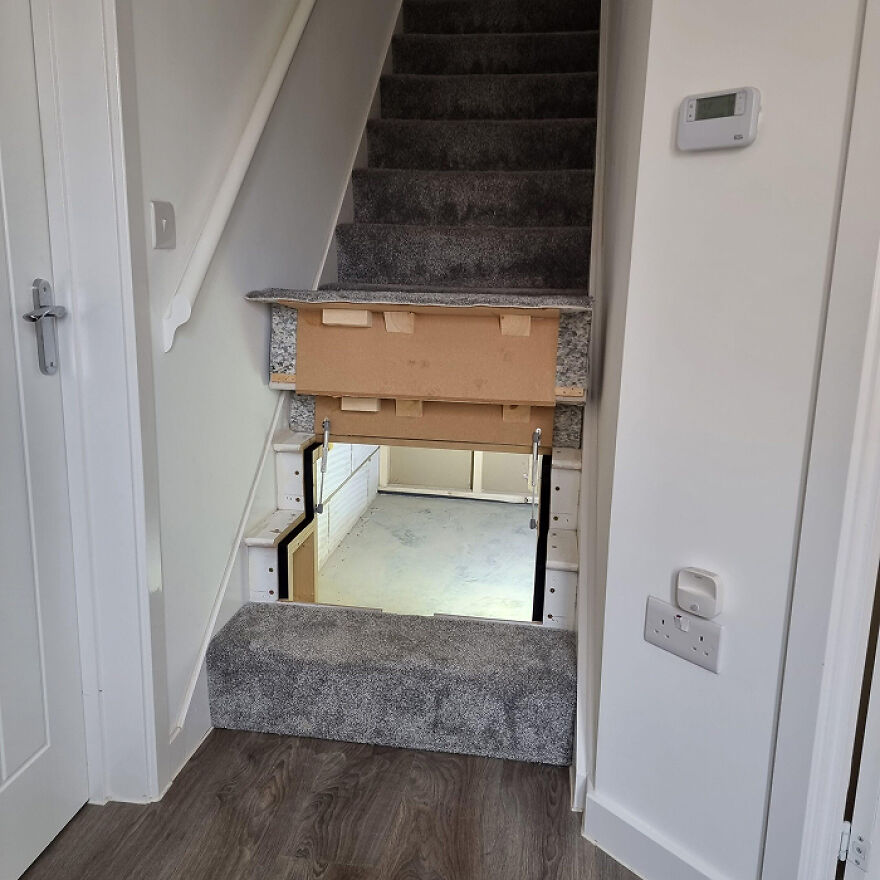 Under-stair storage compartment in a home demonstrating creative organization hacks for better space utilization.