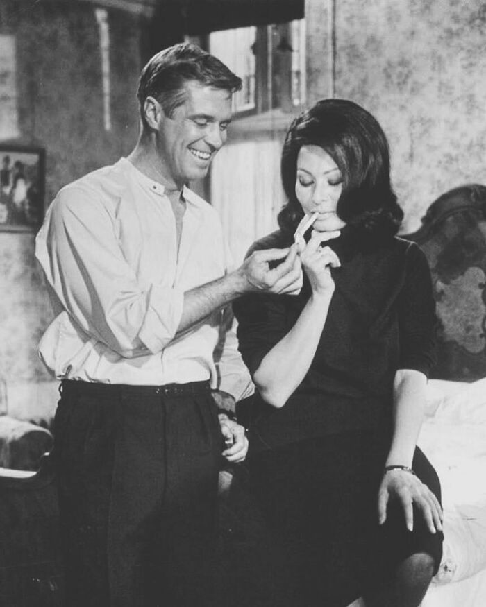 Black and white photo of Sophia Loren enjoying a moment with a man, showcasing Italian beauty and Hollywood legend charm.