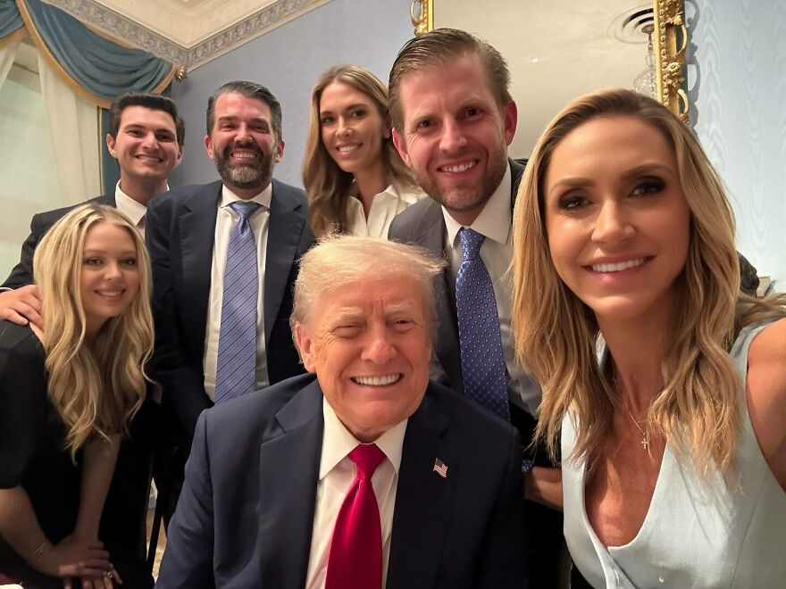Group selfie including Lara Trump, smiling with family members in a formal room, highlighting early years to Maga star transformation.